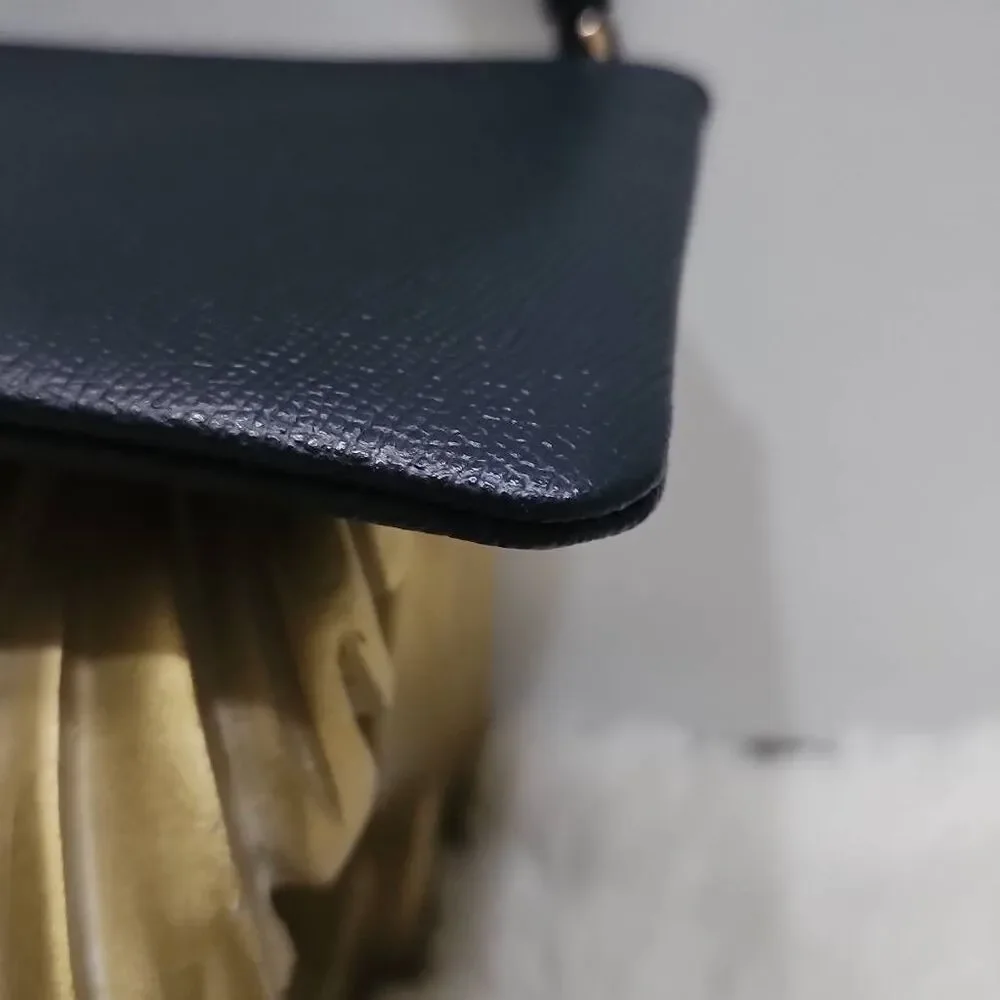 Coach Corner Zip Wristlet in crossgrain leather.